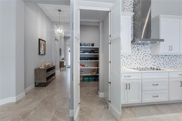 interior space with a notable chandelier, vanity, and backsplash