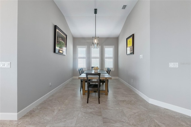 dining room with lofted ceiling