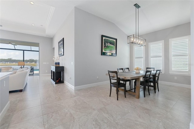 tiled dining area with an inviting chandelier and vaulted ceiling