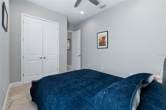 carpeted bedroom with ceiling fan and a closet