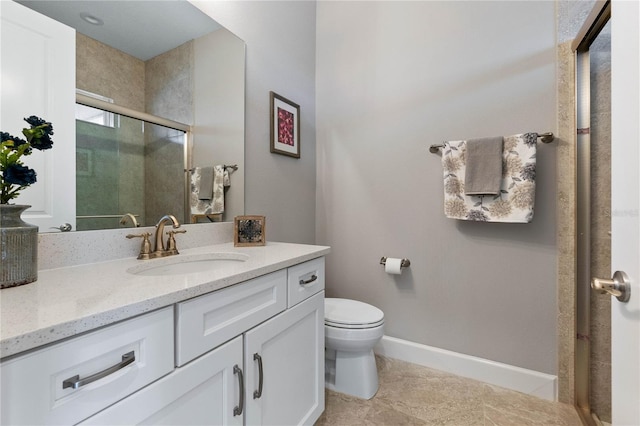 bathroom featuring a shower with door, vanity, tile patterned floors, and toilet