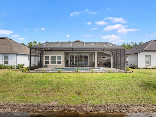 back of house featuring a lanai, a lawn, and a patio area