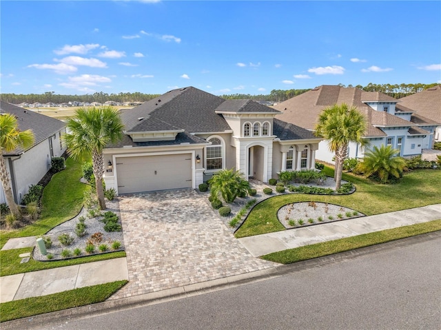 view of front of home featuring a garage and a front lawn