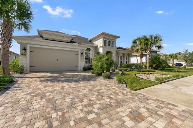 view of front of house with a garage and a front lawn