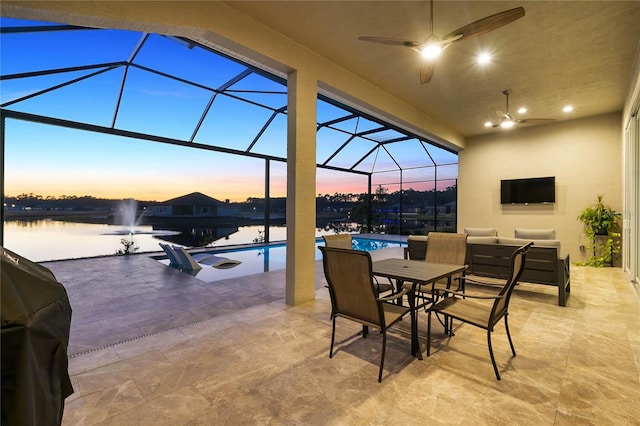 view of patio / terrace featuring area for grilling, a lanai, outdoor lounge area, and ceiling fan