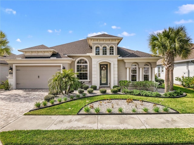 mediterranean / spanish house featuring a garage and a front yard