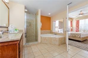 bathroom featuring tile patterned flooring, vanity, separate shower and tub, and ceiling fan