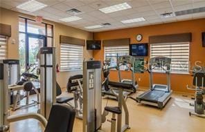 gym with a paneled ceiling