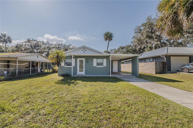 view of front of home with a carport and a front yard