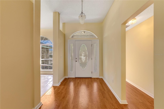 entryway featuring hardwood / wood-style flooring and a textured ceiling