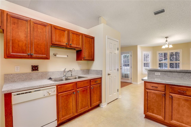 kitchen with sink, a textured ceiling, white dishwasher, a notable chandelier, and pendant lighting