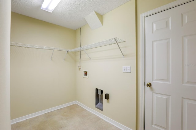 laundry room with hookup for a washing machine and a textured ceiling