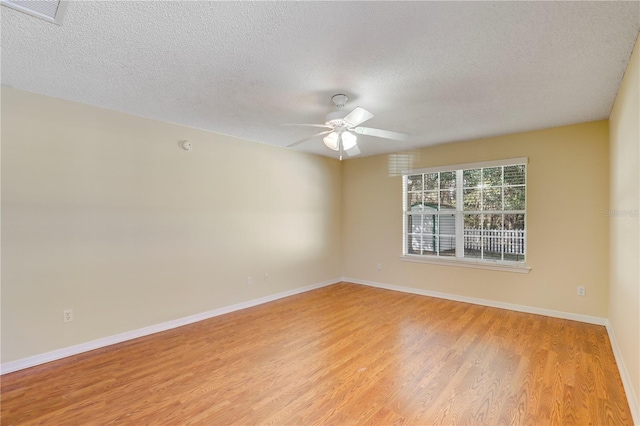 unfurnished room featuring ceiling fan, light hardwood / wood-style flooring, and a textured ceiling