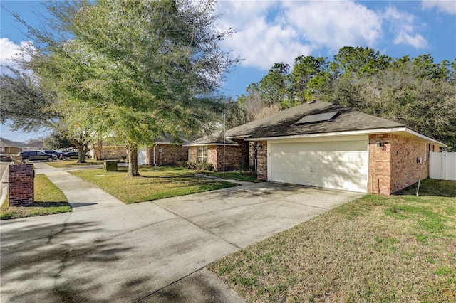 view of front of property with a garage and a front lawn