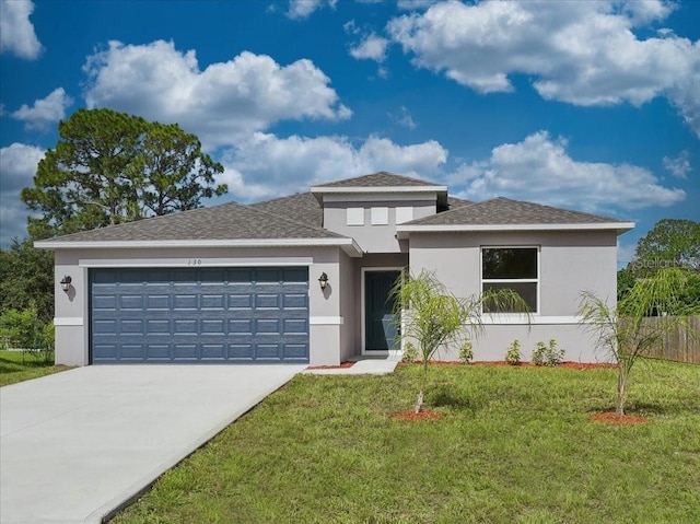 view of front of property featuring a garage and a front yard