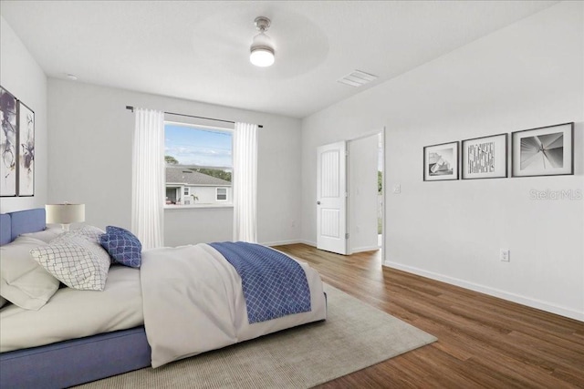 bedroom with hardwood / wood-style floors and ceiling fan