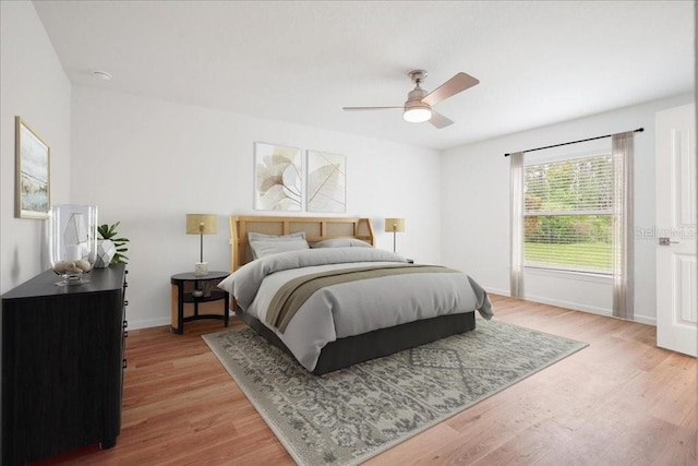 bedroom with ceiling fan and light wood-type flooring