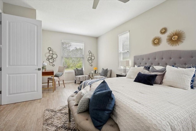 bedroom with ceiling fan and light hardwood / wood-style floors