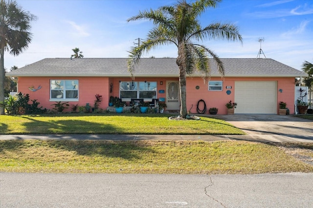 ranch-style house featuring a garage and a front lawn