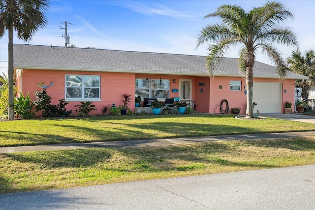 single story home with a garage and a front lawn