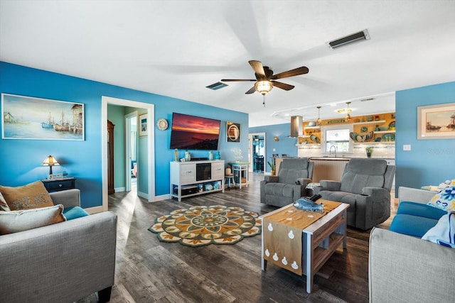 living room with dark wood-type flooring, sink, and ceiling fan