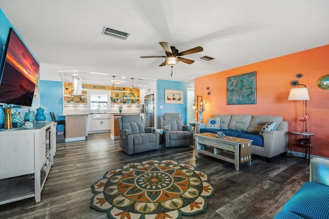 living room with sink, dark wood-type flooring, and ceiling fan