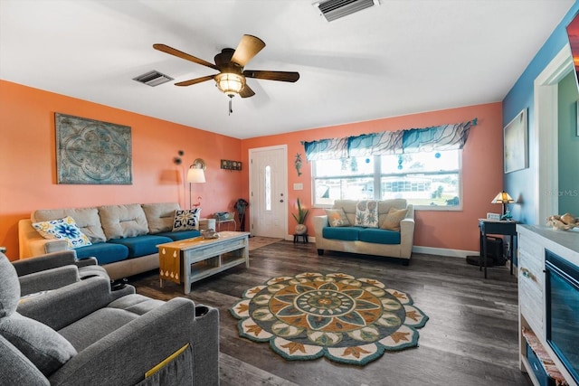 living room with ceiling fan and dark hardwood / wood-style floors