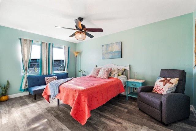 bedroom with dark hardwood / wood-style floors and ceiling fan