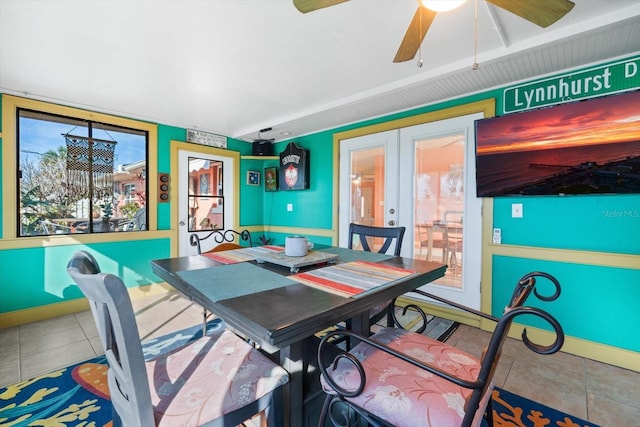 dining space featuring tile patterned floors, french doors, and ceiling fan