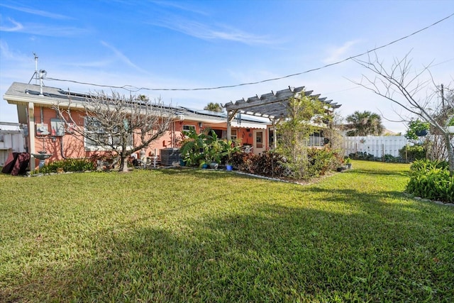 view of yard featuring central AC and a pergola