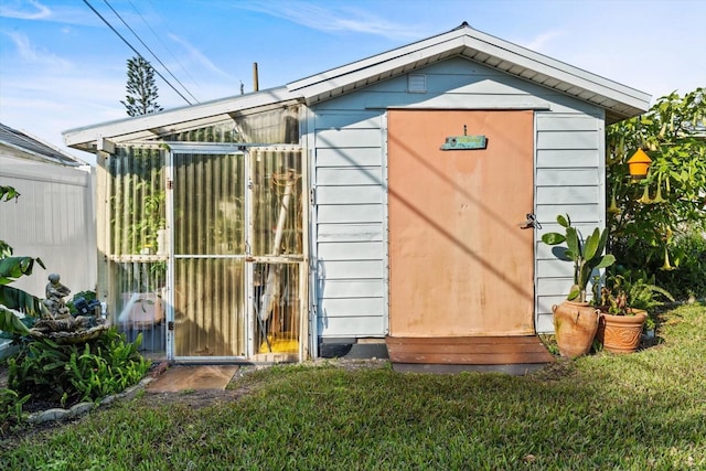 view of outbuilding featuring a lawn