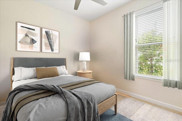 bedroom with hardwood / wood-style flooring and ceiling fan