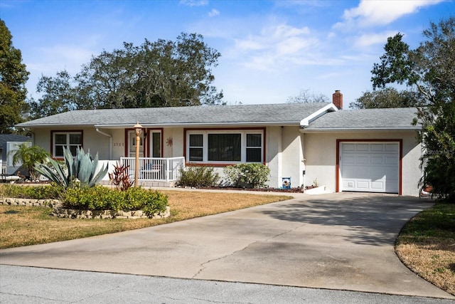 ranch-style home featuring a garage and covered porch