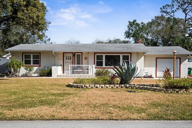 ranch-style house with a garage, a front yard, and a porch