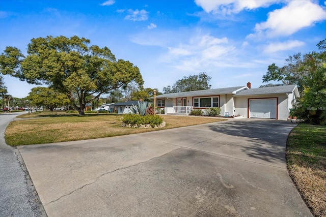 ranch-style home with a garage, a porch, and a front lawn