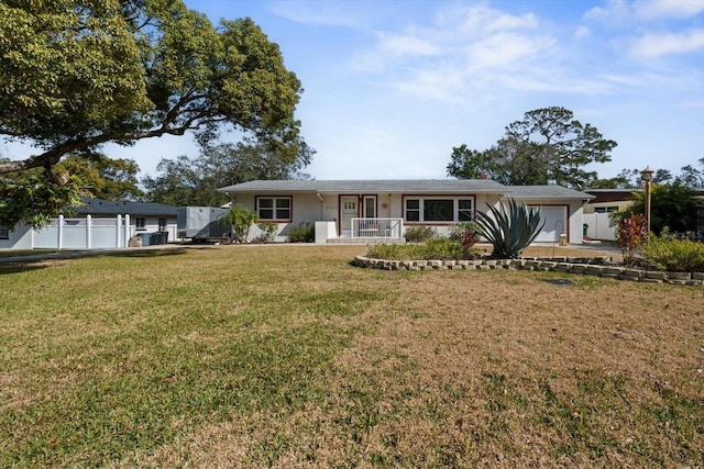 ranch-style house with a garage and a front lawn