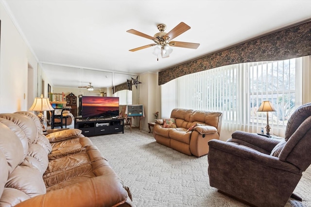 carpeted living room featuring crown molding and ceiling fan