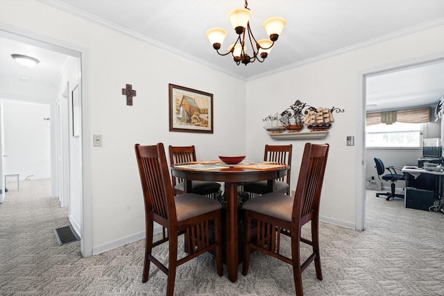 dining area with crown molding, carpet, and a notable chandelier