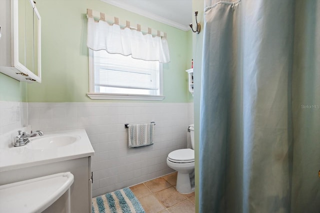 bathroom with crown molding, tile walls, vanity, tile patterned floors, and toilet