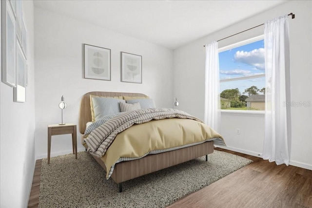 bedroom with hardwood / wood-style flooring