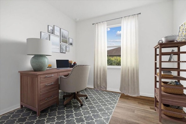 office with light wood-type flooring