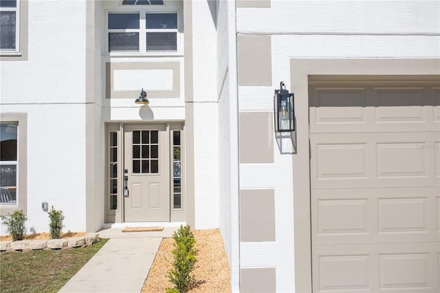 view of exterior entry with a garage