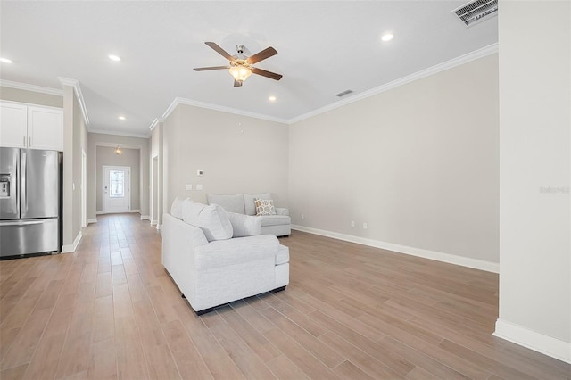 living room featuring crown molding, ceiling fan, and light wood-type flooring