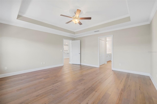 unfurnished room with ceiling fan, a raised ceiling, and light wood-type flooring