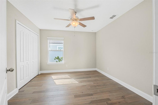 spare room with hardwood / wood-style floors and ceiling fan