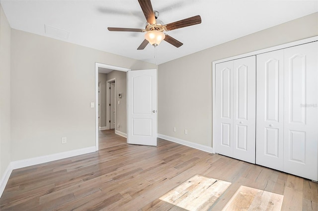 unfurnished bedroom with ceiling fan, light hardwood / wood-style floors, and a closet