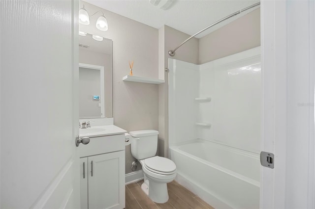 full bathroom featuring vanity, a textured ceiling, washtub / shower combination, and toilet