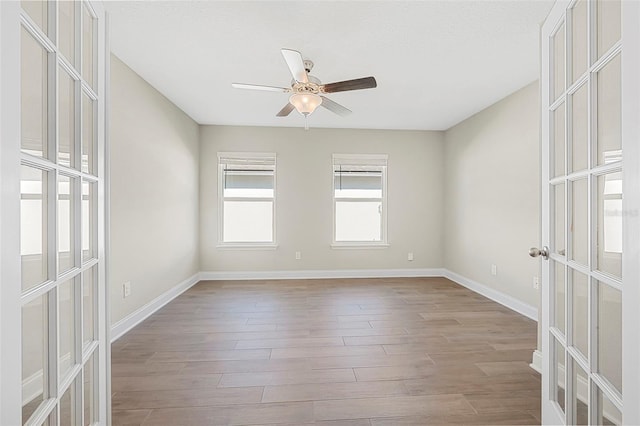 empty room featuring light hardwood / wood-style floors, french doors, and ceiling fan