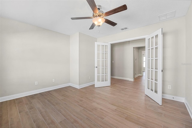 unfurnished room featuring french doors, ceiling fan, and light hardwood / wood-style floors