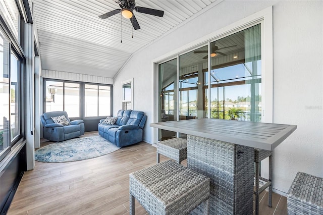 sunroom featuring ceiling fan and vaulted ceiling